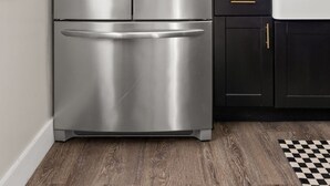 A stainless steel refrigerator with a water dispenser, a wooden countertop, a sink, and a checkered floor mat. - Stylish + Trendy Home W/ Office Near It All! (Indianapolis)