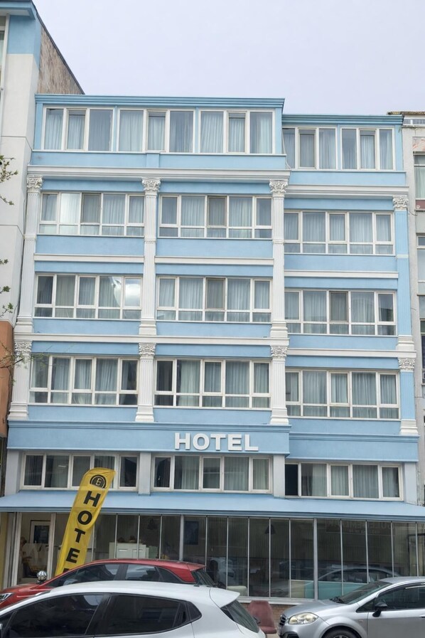 A multi-story hotel building with a blue facade, large windows, and a prominent 'HOTEL' sign. - Elit öztürk otel (Ankara)