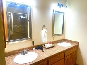 A bathroom with two sinks, a towel rack, and a mirror. - Flat Creek Overlook is a beautiful place to stay 20 min from roaring river! (Cassville)