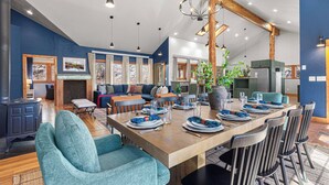 A spacious dining area with a wooden table set for six, surrounded by modern chairs. - Last Stand Pines is a charming cabin in Custer perfect for family getaways (Custer)