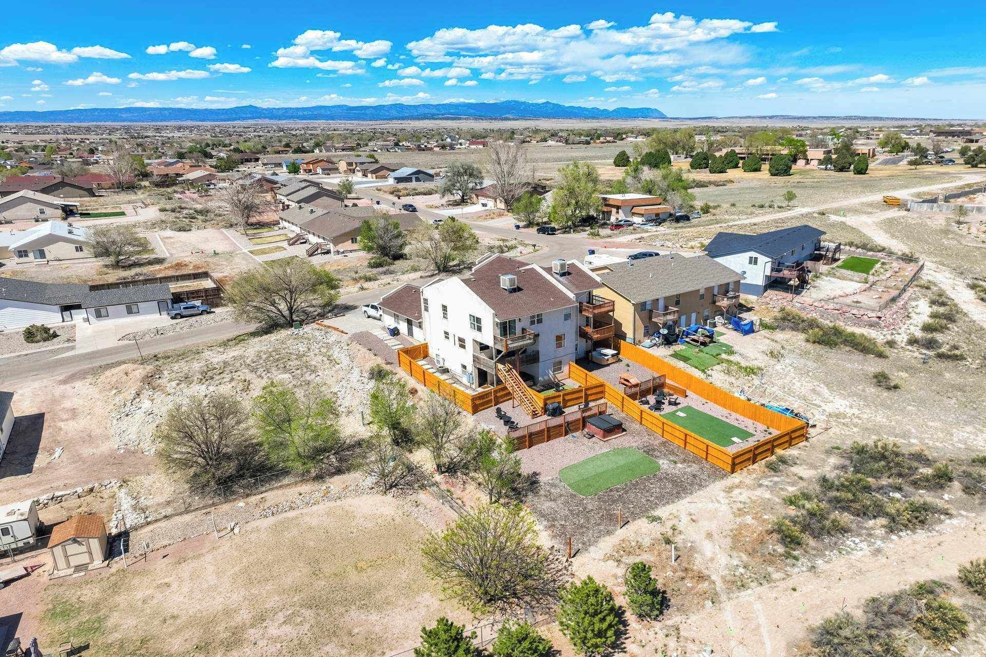 A residential area with houses, a playground, and a clear view of distant mountains.