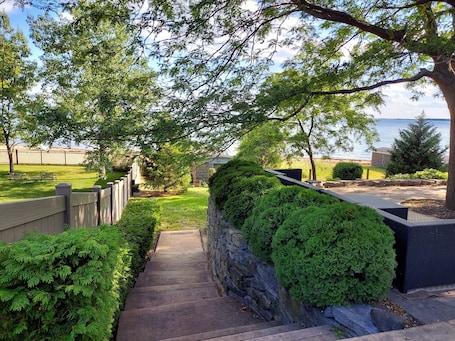 Property grounds. Cozy 3-bedroom cottage with private sandy beach, fire pit and relaxing patio