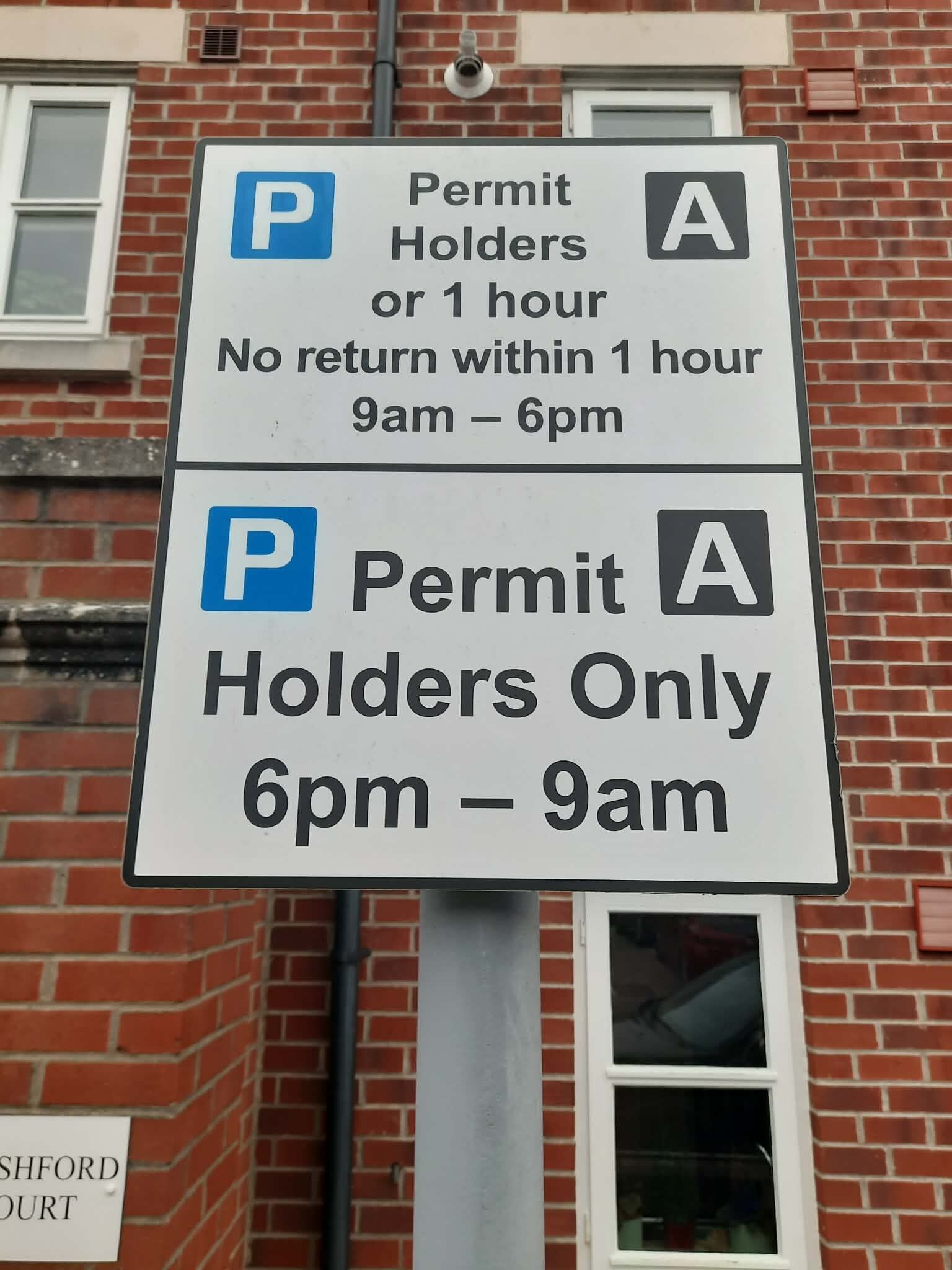 A parking sign with time-specific instructions for permit holders.