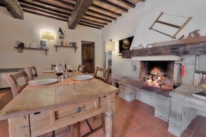 A rustic dining area with a wooden table, chairs, and a fireplace. - SwimmingPool ONLY FOR YOU in Villa with AirCon for 26/30 pax in 13 bedrooms (Toscana)