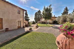 A courtyard with a building, potted plants, and a grassy area. - SwimmingPool ONLY FOR YOU in Villa with AirCon for 26/30 pax in 13 bedrooms (Toscana)