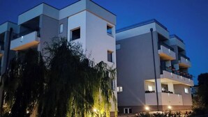 A modern multi-story building with balconies and a clear sky. - Dalmatia Apartments-Studio Apartment with Balcony 3a (Drage)
