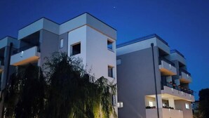 A modern multi-story building with balconies and a clear sky. - Dalmatia Apartments- Studio Apartment with Balcony and Sea View 4a (Drage)