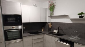 Een moderne keuken met inbouwapparatuur, een spoelbak en een vaatwasser.