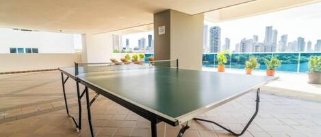 Ping pong-bord i et udendørs område med udsigt over byen.