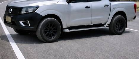 A white pickup truck parked on a road.