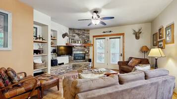 A living room with a fireplace, television, and seating area.