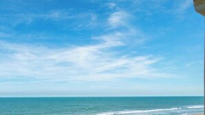 A beach with a clear sky and calm sea. - Oceanview I 3rd FL I Quiet Beach Escape I Beach (Cocoa Beach)