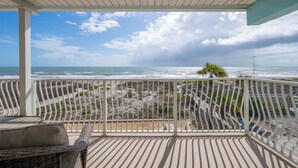 A covered balcony with a view of the beach and ocean. - Oceanview I 3rd FL I Quiet Beach Escape I Beach (Cocoa Beach)