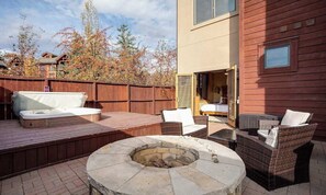 A patio with a hot tub, outdoor seating, and a fire pit. - Trappeur's Aspen Oasis, Resort Amenities with Private Access (Steamboat Springs)