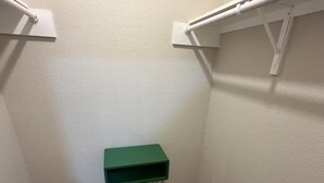 A small, narrow room with a green table, tiled floor, and white walls. - Relax and Refresh at this Studio Apt. in South ATX (Austin)