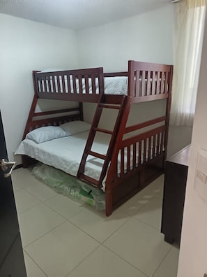 A bunk bed with a ladder, a small desk, and a door. - Your Tropical Oasis Awaits in Jacó, Costa Rica! (Jaco)