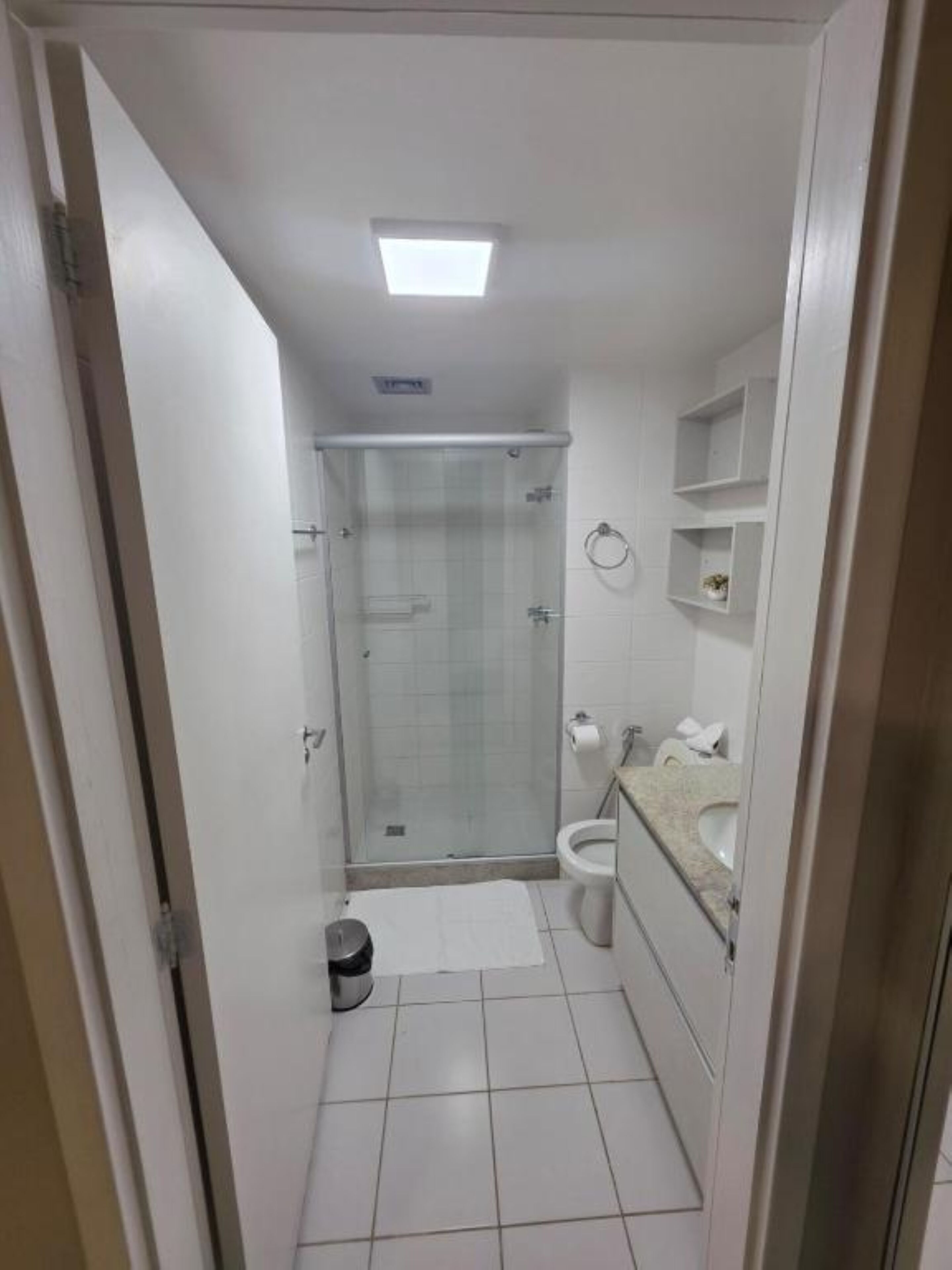 A bathroom with a shower, toilet, and sink.