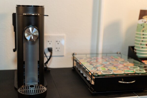 A black electronic device with a dial, a glass display case with colorful items, and a black drawer.