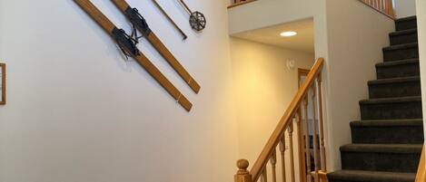 A staircase with wooden railings and carpeted steps.