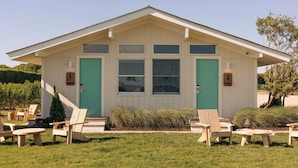 A building with a gabled roof, large windows, and a door with a number. - Barlume Beach Montauk (Montauk)
