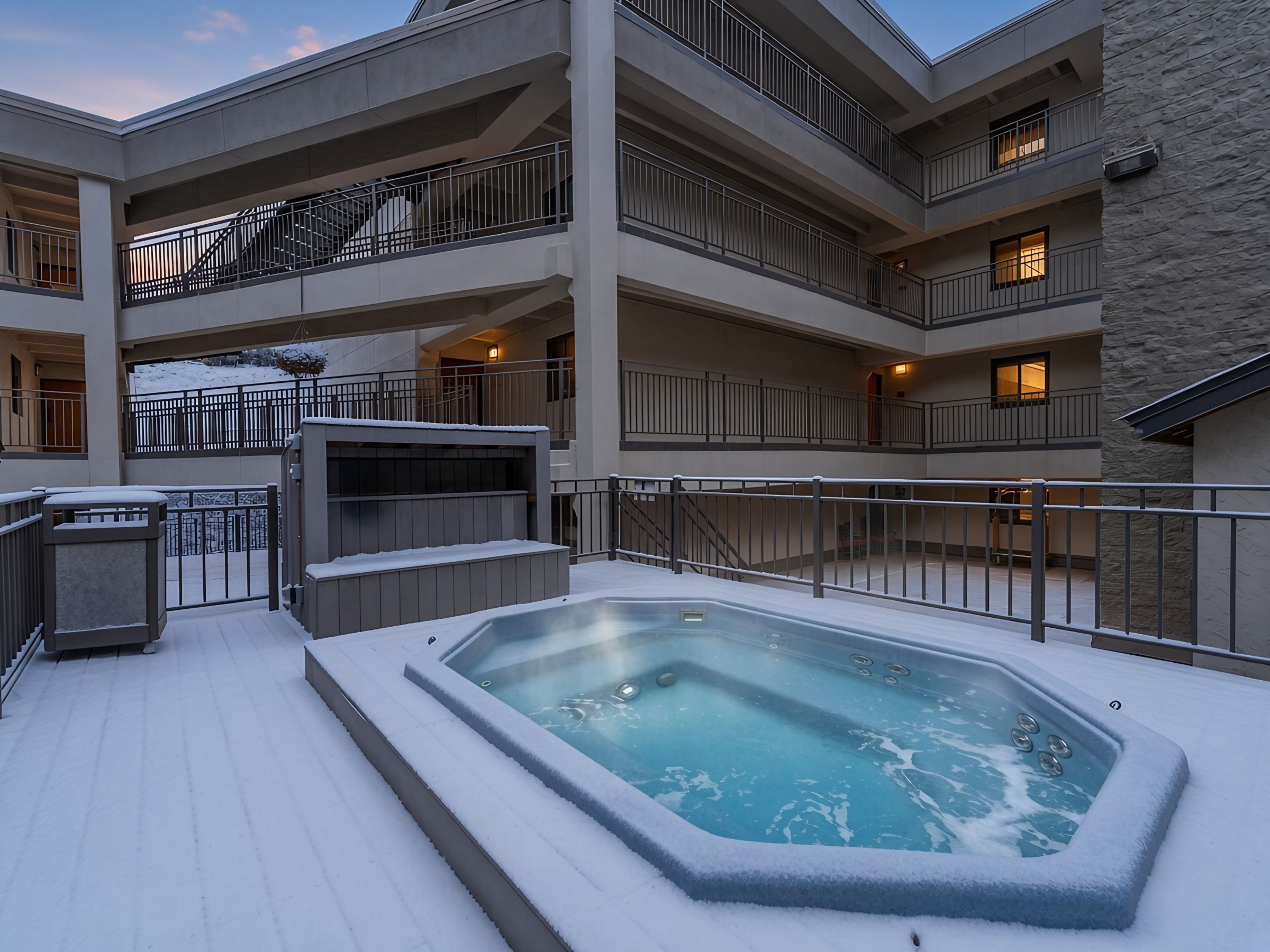 【Hot Tub at Twilight】Shared outdoor deck hot tub — steam rising off the snowy deck at dusk