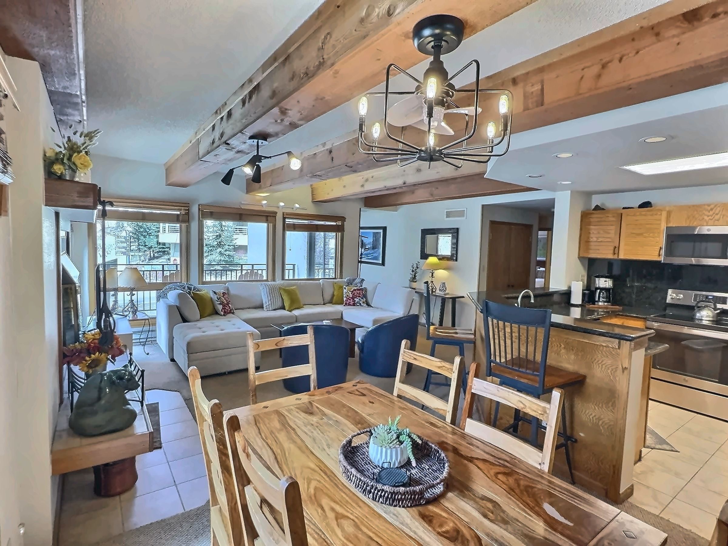 A modern kitchen with wooden cabinets and a dining area with a wooden table and chairs.