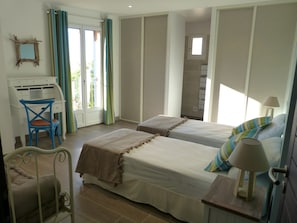 A bedroom with two beds, a desk, and a chair. - Vista di Sognu (Monticello)