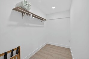 A room with a wooden floor, a white wall, and a ceiling light. - Central Tampa 3BR/2BA • Near Stadium & Airport (Tampa)