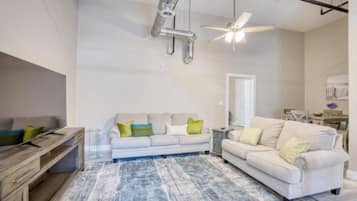 A modern living room with a sofa set, a coffee table, and a rug.