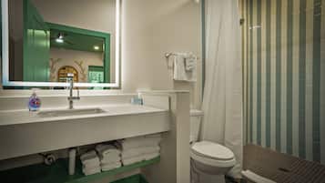 A bathroom with a sink, toilet, and shower.