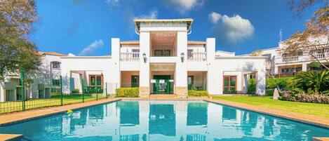 A swimming pool with a building in the background.
