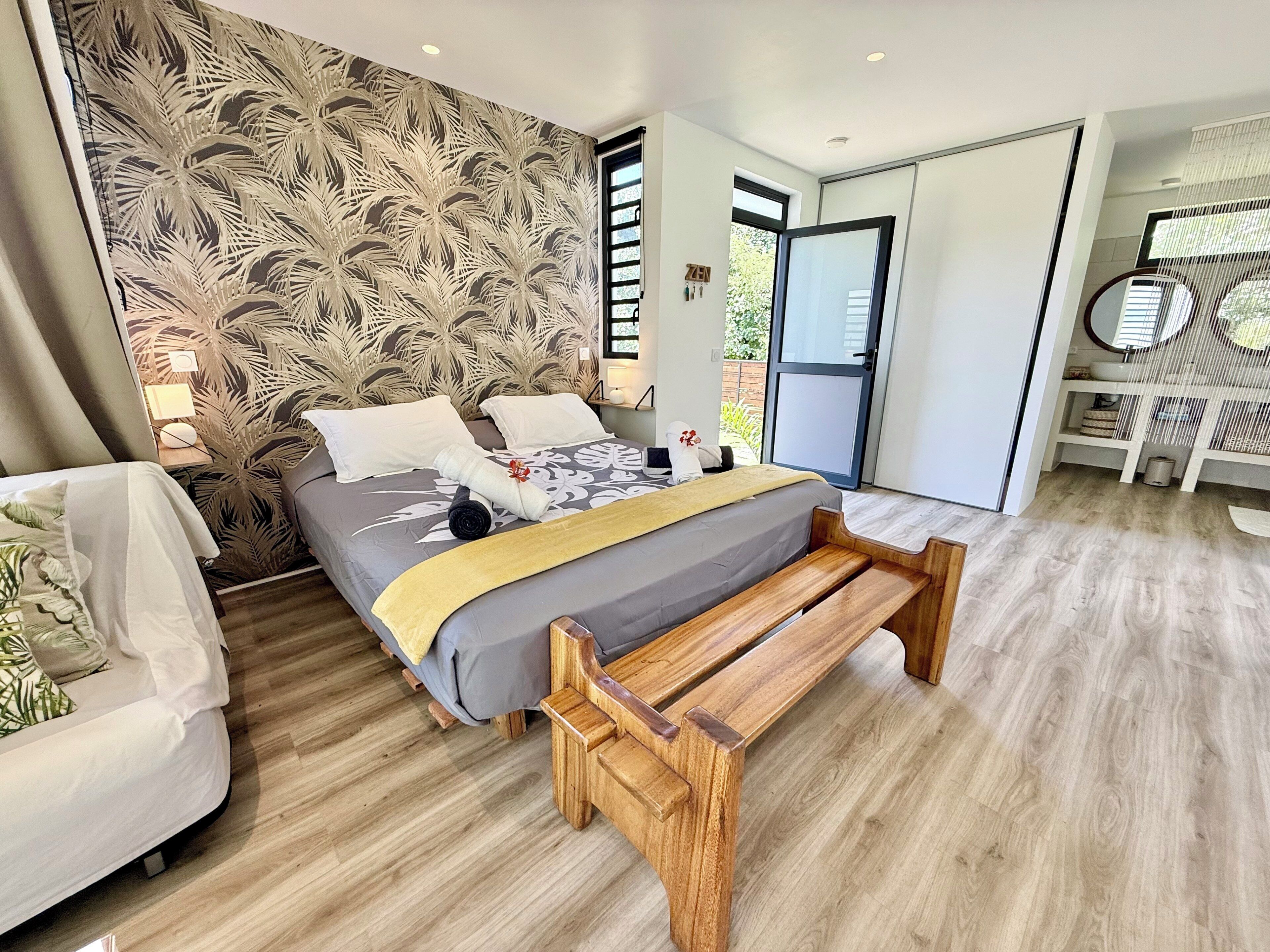 A modern bedroom with a bed, bedside table, and a bench.