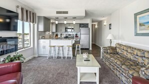 A modern apartment with a kitchen, dining area, and living room. - Oceanfront Corner Unit-Crescent Towers I 804-Pool (North Myrtle Beach)