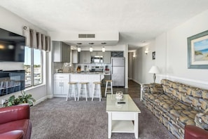 A modern apartment with a kitchen, dining area, and living room. - Oceanfront Corner Unit-Crescent Towers I 804-Pool (North Myrtle Beach)