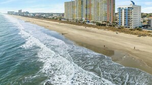 A coastal hotel with multiple high-rise buildings, a sandy beach, and the ocean. - Oceanfront Corner Unit-Crescent Towers I 804-Pool (North Myrtle Beach)