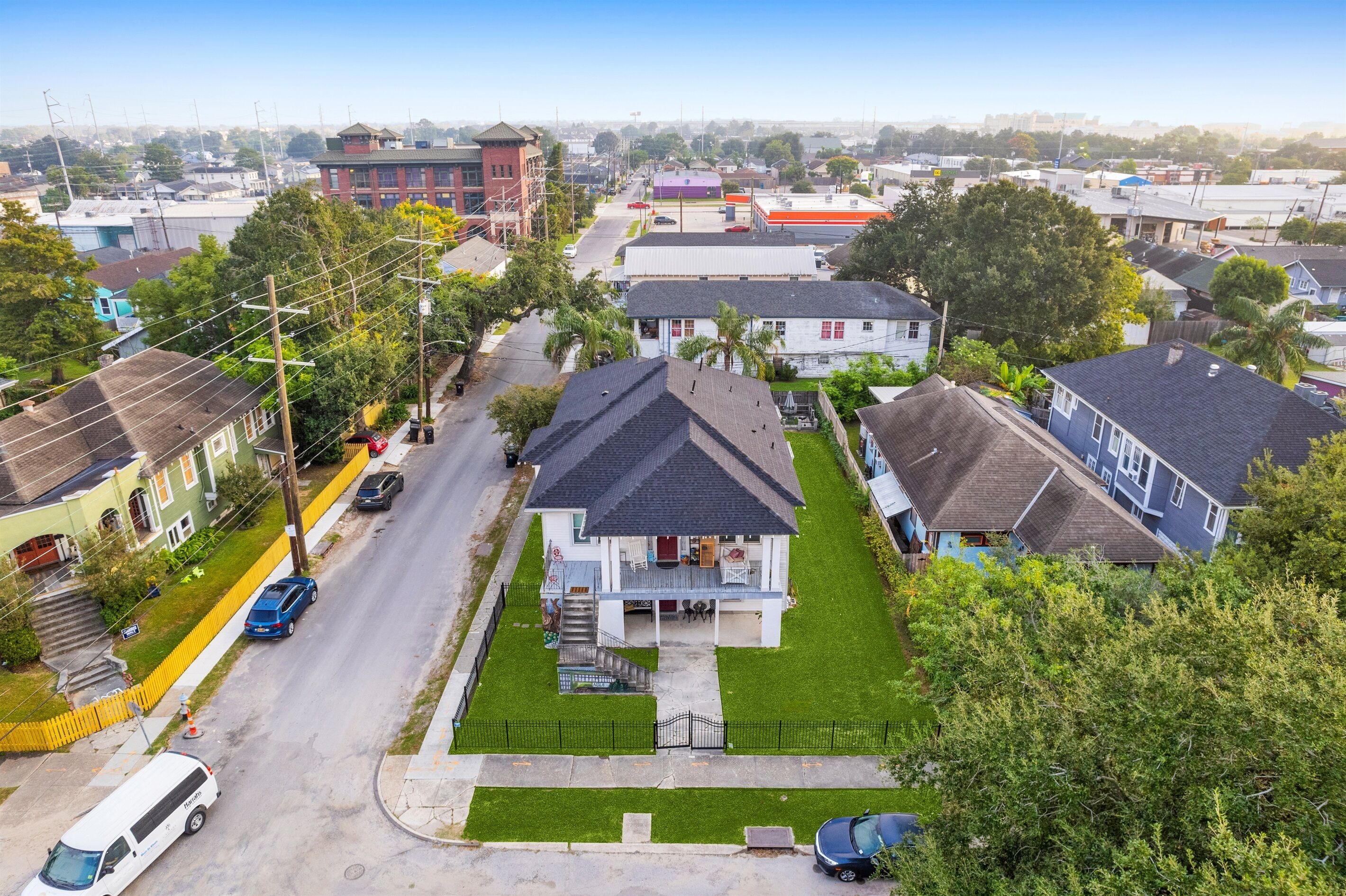 A residential area with houses, a street, and a clear sky.