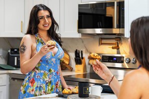 A kitchen with white cabinets, a microwave, a toaster, and a coffee maker. - Eternity Wellness Retreat Jacuzzi/Sauna/ColdPlunge (Tampa)
