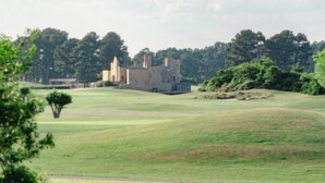 A castle-like building with a grassy landscape and trees in the background. - Tee Time Retreat- Pool Access + Premier Golf (Myrtle Beach)