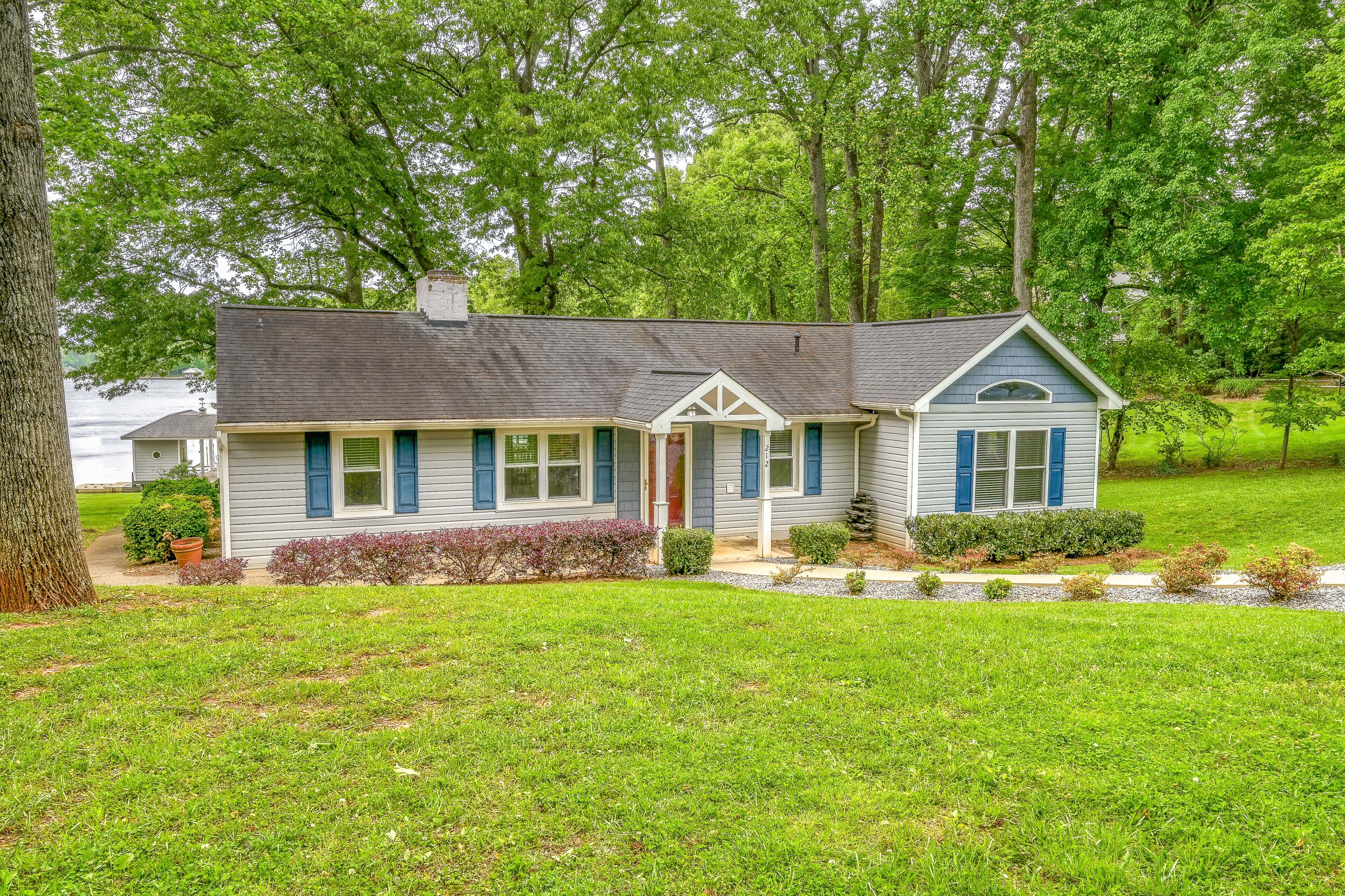 A single-story house with a gabled roof, a front porch, and a small attached garage.