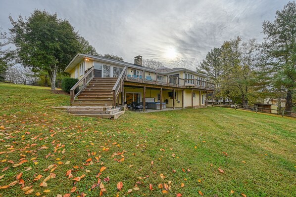A two-story house with a covered porch and a staircase leading to the upper level.
