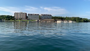 Un hôtel situé au bord de l’eau, composé de plusieurs bâtiments, doté d’un quai et de bateaux.
