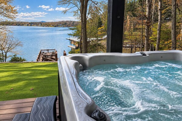 A hot tub with a view of a lake and trees. - LakeDaze - Dog-friendly, Lakefront, Dock, Hot Tub, Putting Green, Game Room (Moneta)