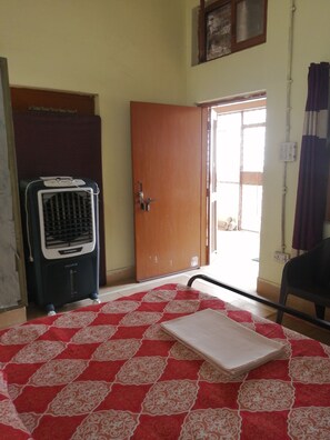 A room with a radiator, a door, a window, and a chair. - Superb 1-bedroom studio in vibrant Vrindavan for your stay near Iskcon Vrindavan (Vrindavan)