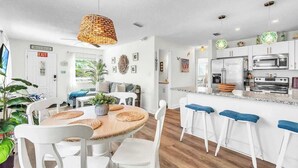 A modern kitchen with white cabinets, a built-in oven, and a microwave. - Beach in 90 Seconds w/ Hot Tub, Coffee Bar & Games (Indian Rocks Beach)