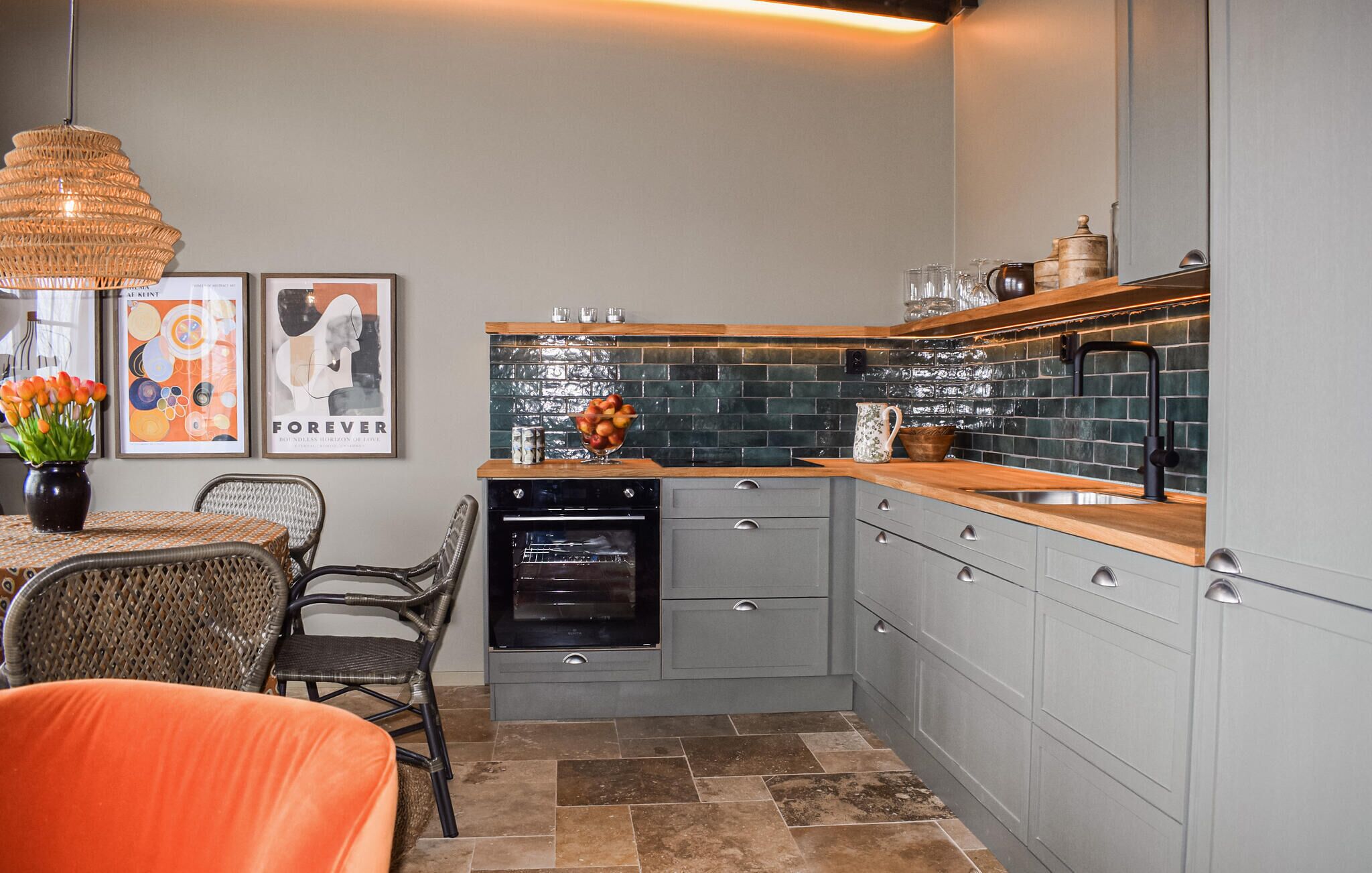 A compact kitchen with grey cabinetry, a dishwasher, and a tiled backsplash.