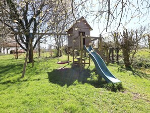 A playground with a slide and swings.