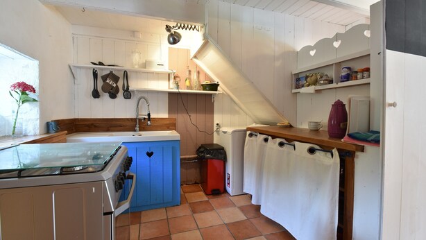 A kitchen with a stove, sink, and blue cabinets. - Brittany Escape With Garden (Cleden-Cap-Sizun)