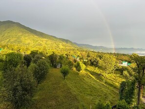 A hilly landscape with trees and a rainbow. - The Billing Health Resort (Baijnath)