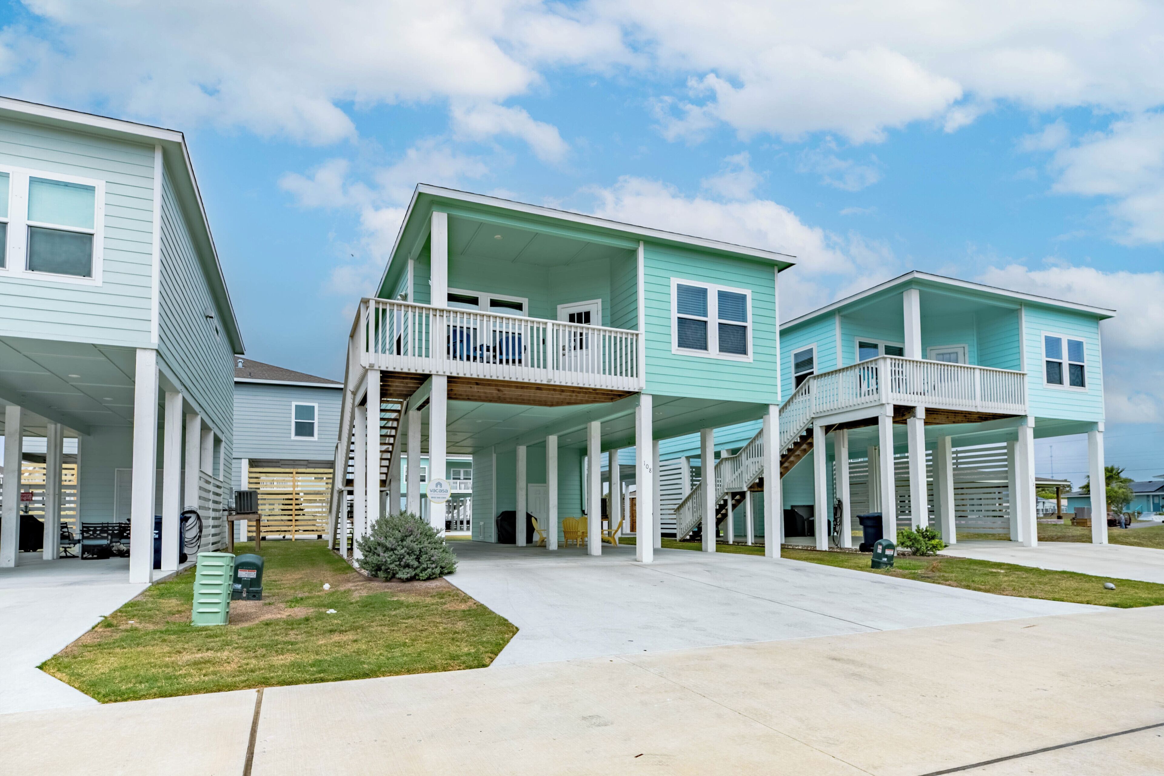 A residential building with a covered porch, a second-story balcony, and a garage.