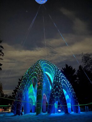 A large, illuminated dome structure with a symmetrical design, supported by multiple pillars. - Lovely Beacon Heights (Edmonton)